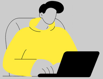 person wearing yellow hoodie using laptop on gray background digital workspace productivity 2 tasks