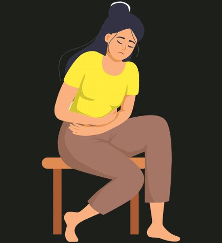 woman sitting on a stool holding her stomach experiencing pain possible stomach discomfort or related issues four symptoms relief